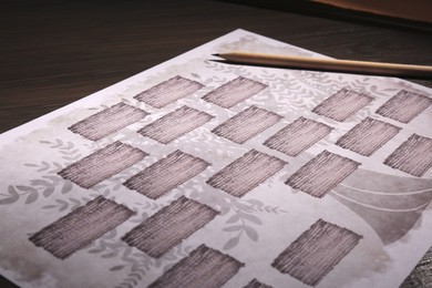 Blank family tree and pencil on wooden table, closeup