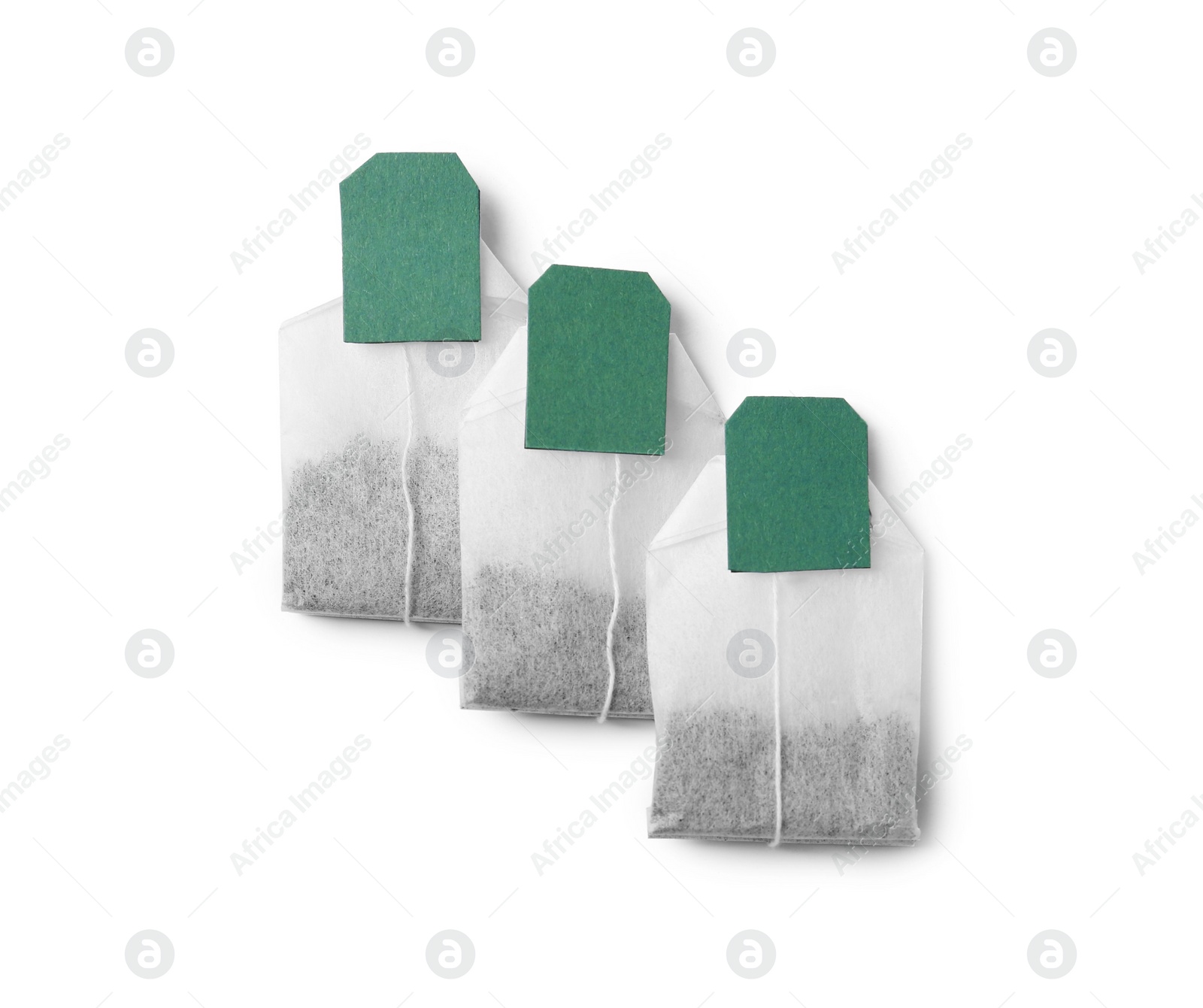 Photo of New tea bags with labels on white background, top view