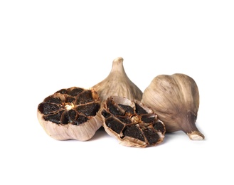 Photo of Aged black garlic on white background. Asian cuisine