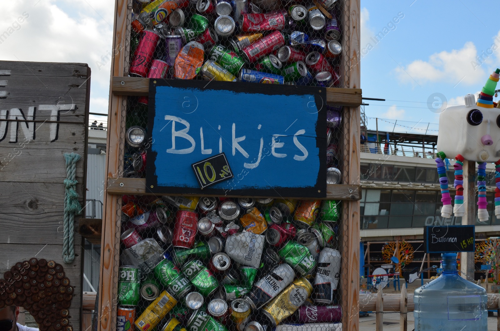 Photo of HAGUE, NETHERLANDS - SEPTEMBER 10, 2022: Container with used tin cans outdoors