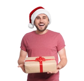 Young man with Christmas gift on white background