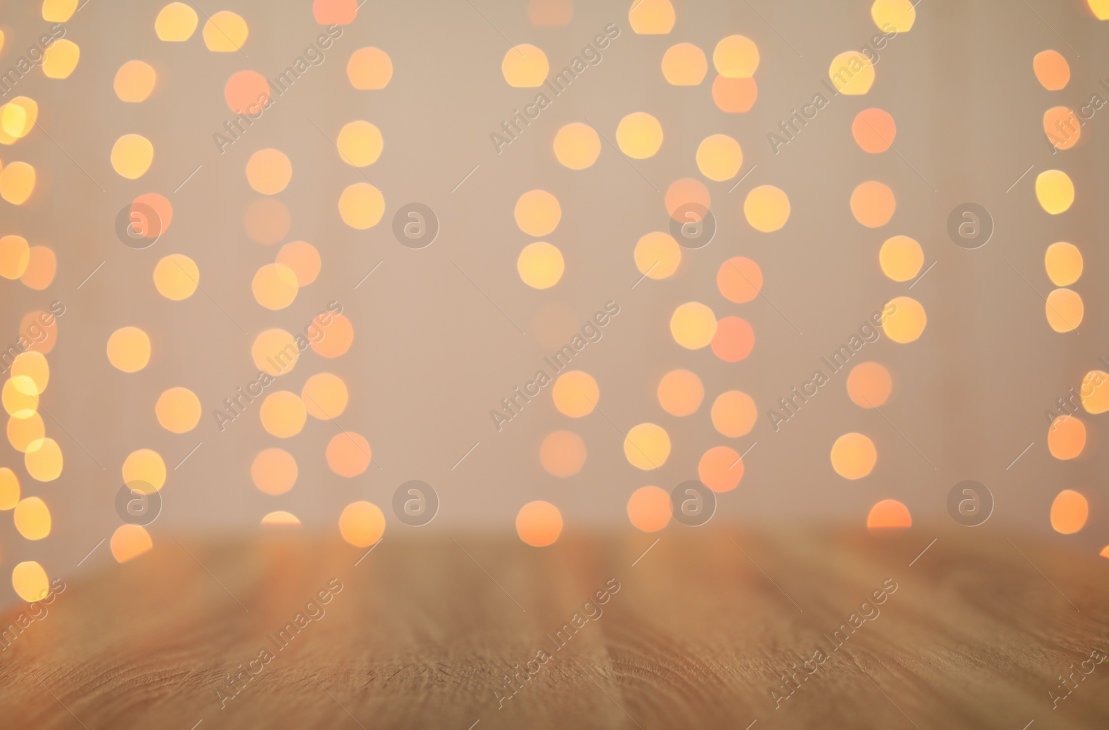 Photo of Empty wooden surface and blurred lights on background. Bokeh effect