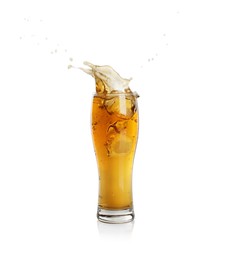 Beer splashing out of glass on white background