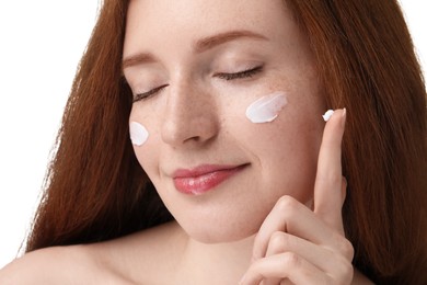 Photo of Beautiful woman with freckles and cream on her face against white background, closeup