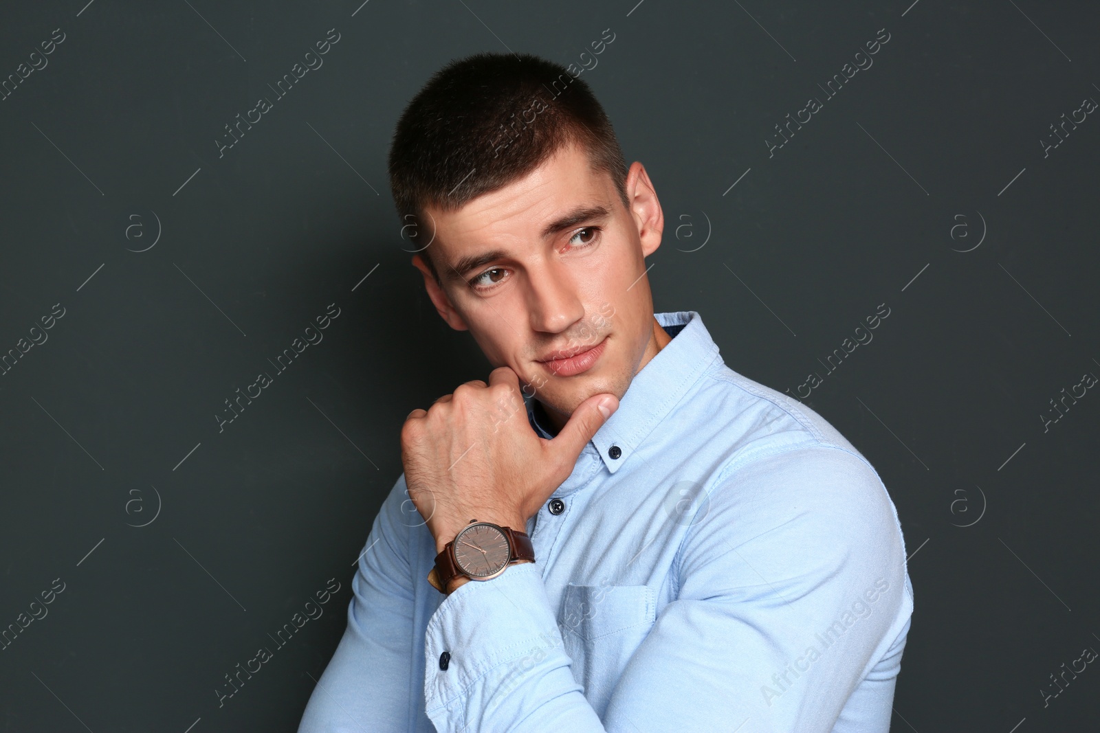 Photo of Portrait of handsome young man on dark background