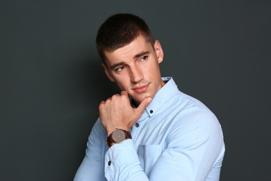 Portrait of handsome young man on dark background