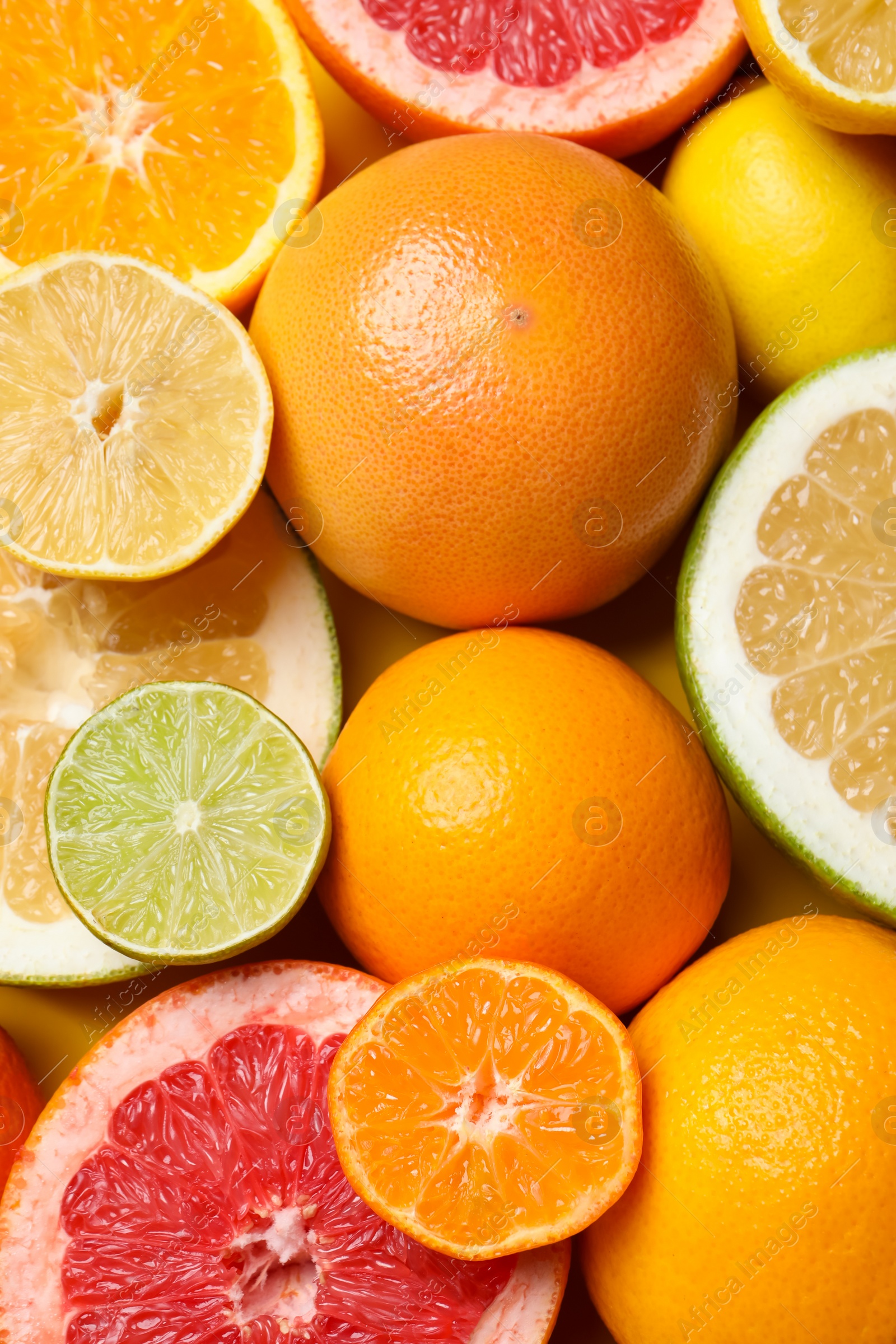 Photo of Different ripe citrus fruits as background, top view