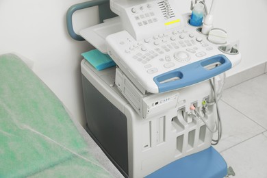 Ultrasound control panel and examination table in hospital, closeup
