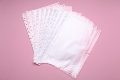 Photo of Punched pockets on pink background, flat lay