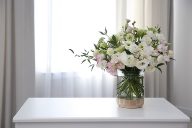 Photo of Bouquet of beautiful flowers on table in room, space for text. Interior design