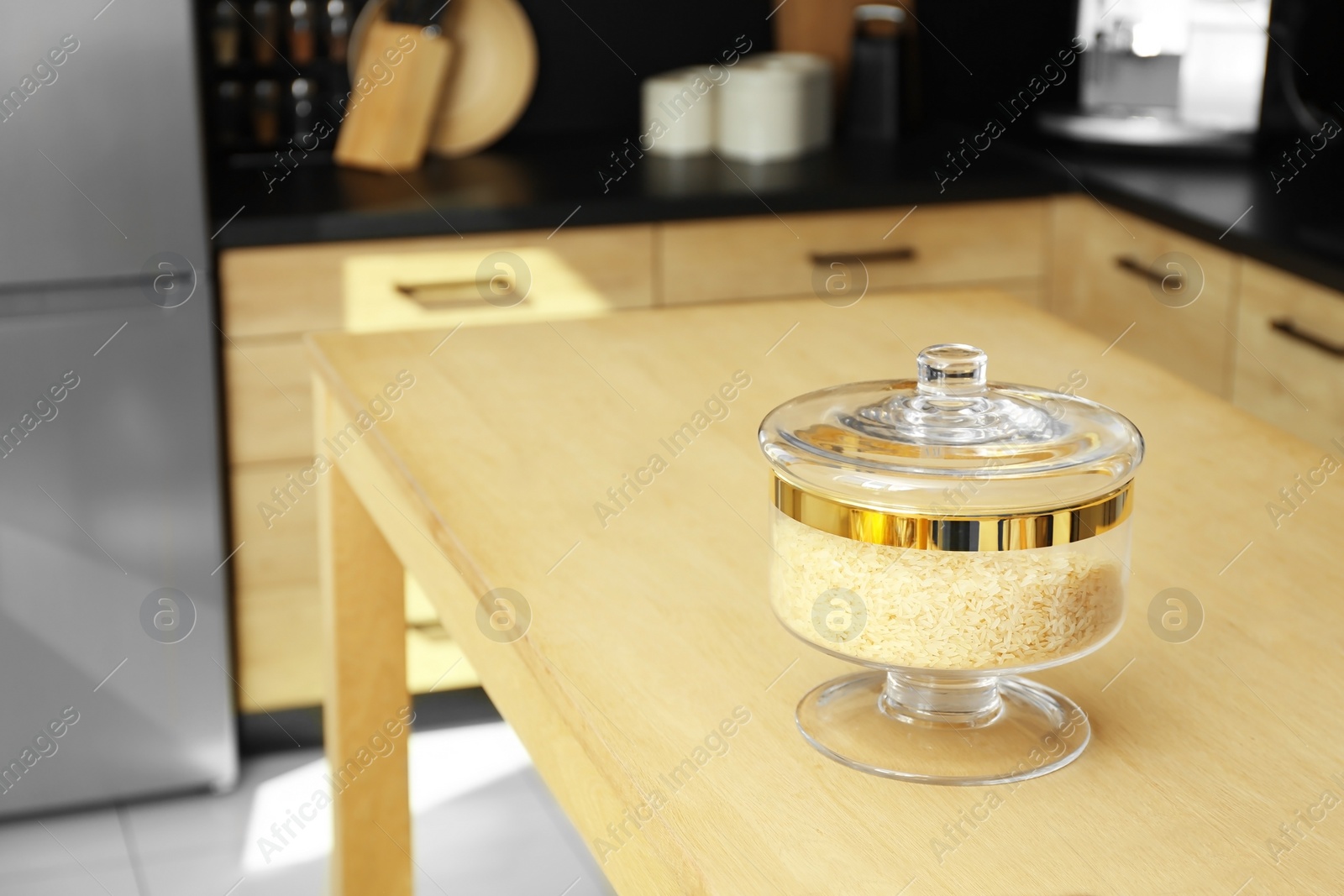 Photo of Products on wooden table in modern kitchen. Space for text
