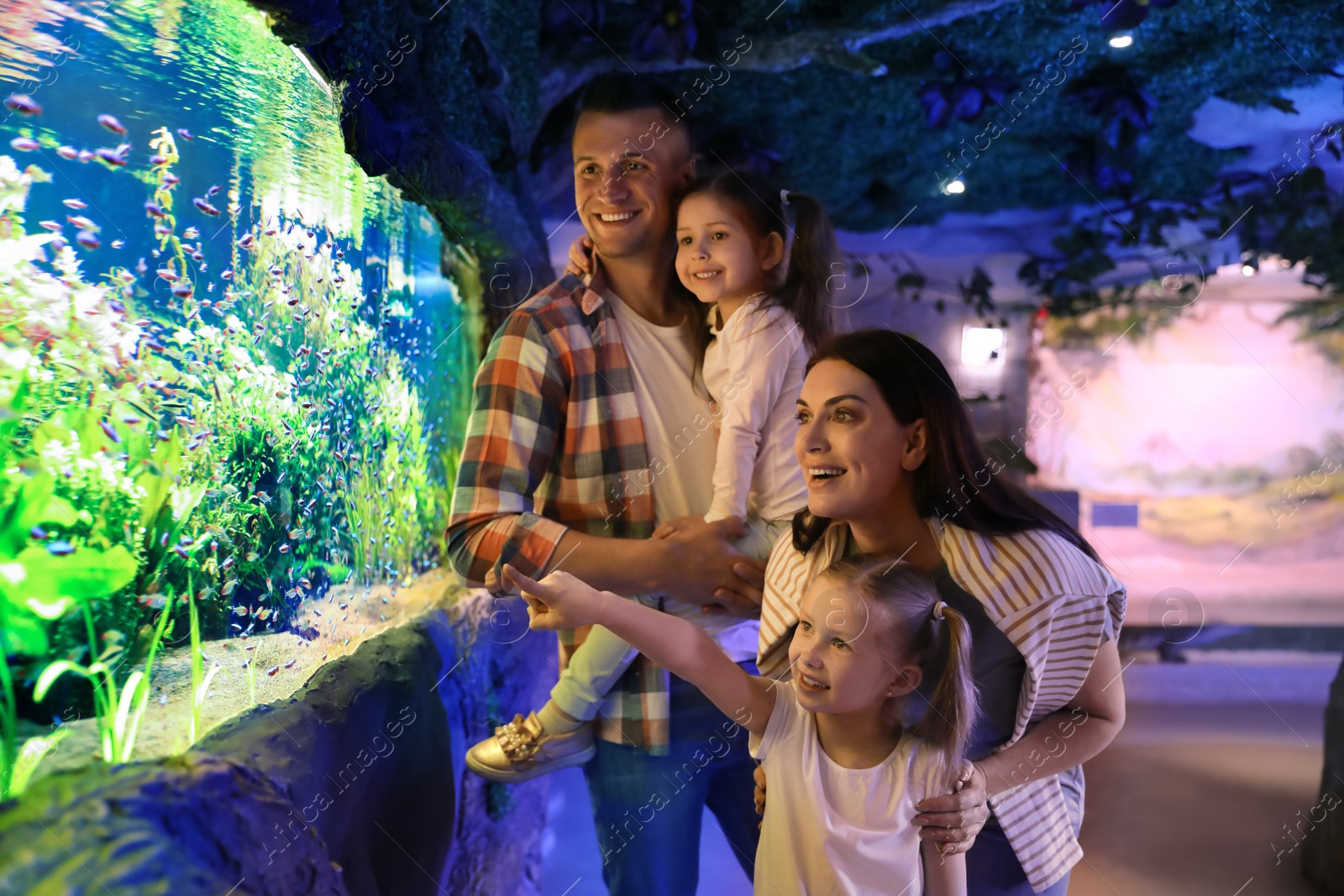 Image of Happy family near aquarium in oceanarium. Spending time together