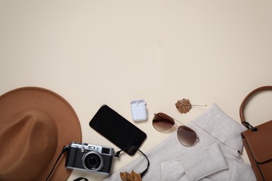 Flat lay composition with stylish hat on beige background, space for text
