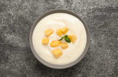 Photo of Delicious yogurt with fresh peach and mint on grey table, top view
