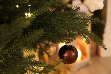 Beautiful bauble and fairy lights on Christmas tree, closeup