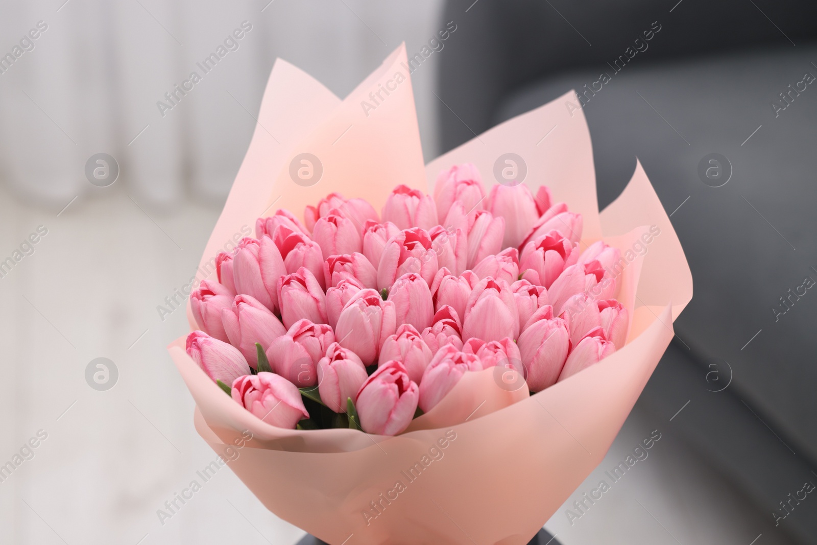 Photo of Bouquet of beautiful pink tulips indoors, closeup