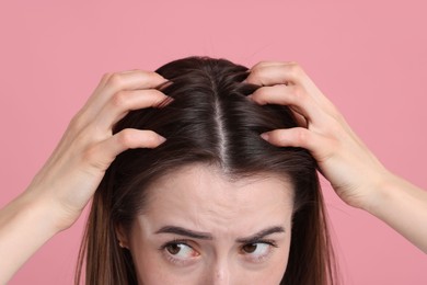 Young woman with hair loss problem on pink background, closeup