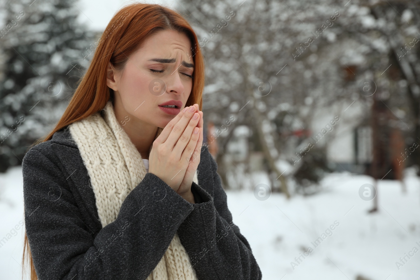 Photo of Beautiful young woman coughing outdoors, space for text. Cold symptoms