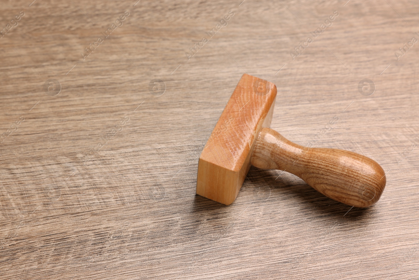 Photo of One stamp tool on wooden table, space for text