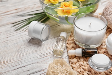 Photo of Composition with spa accessories and flowers on wooden background