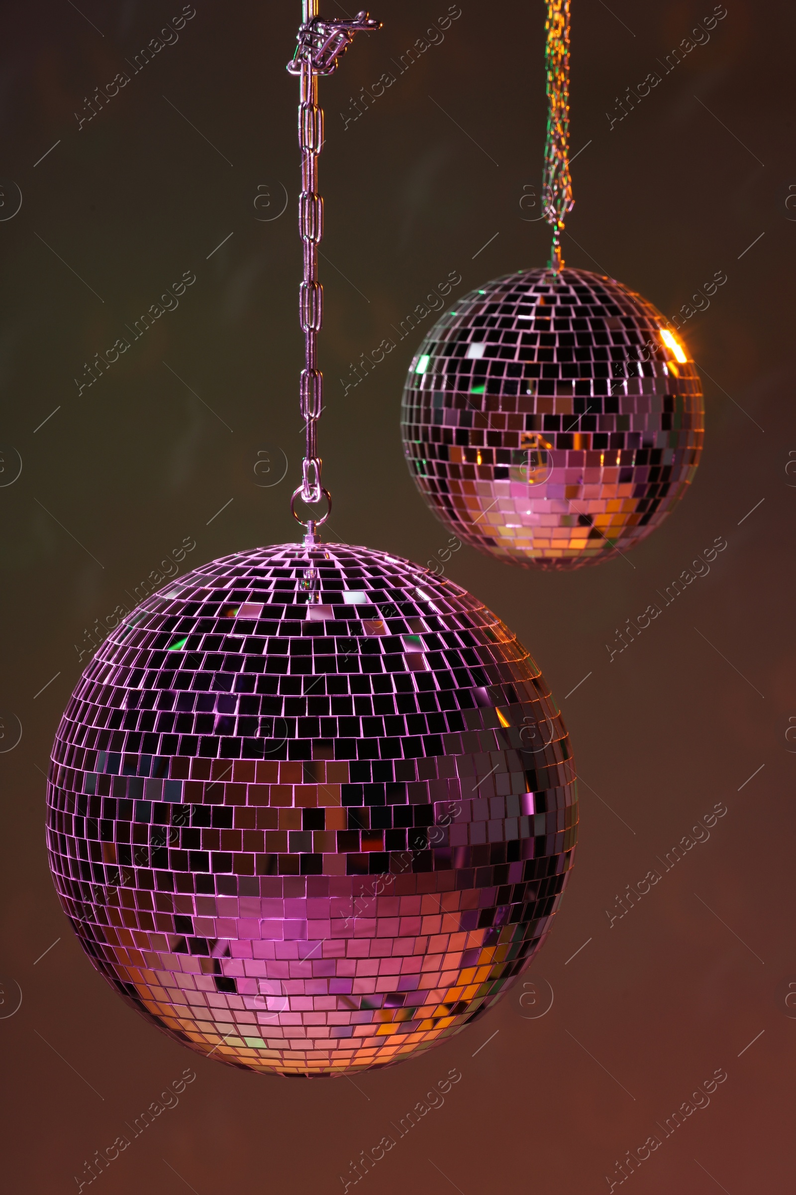 Photo of Shiny bright disco balls under color lights