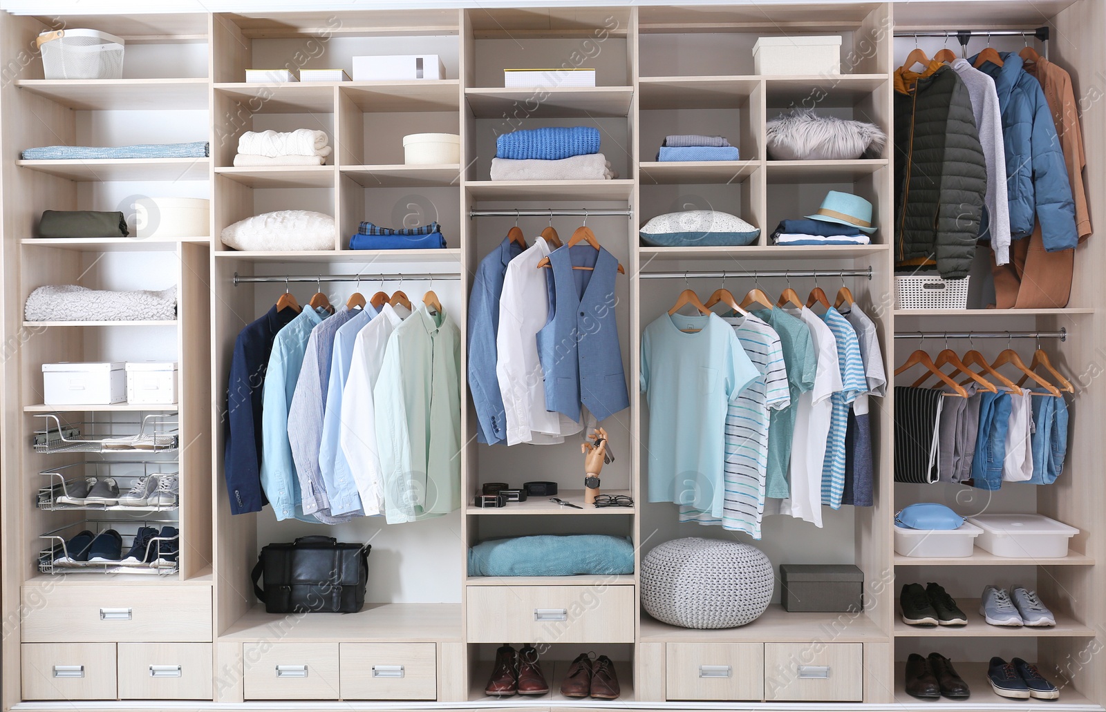 Photo of Stylish clothes, shoes and home stuff in large wardrobe closet