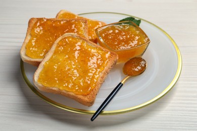 Photo of Delicious toasts with jam served on white wooden table, closeup