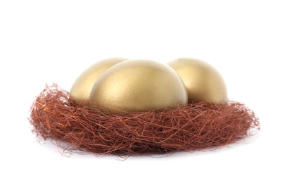 Photo of Golden eggs in nest on white background