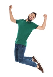 Photo of Happy young man jumping on white background. Celebrating victory