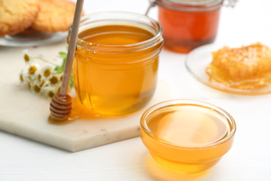 Photo of Tasty fresh honey on white table, closeup