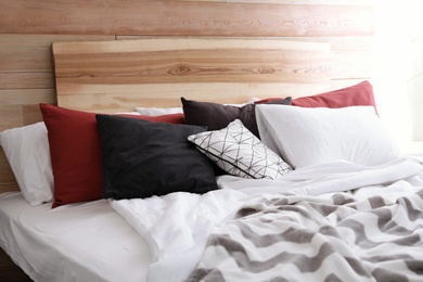Photo of Different pillows on bed in room. Idea for interior decor