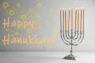 Silver menorah on white wooden table. Happy Hanukkah!