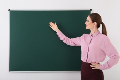 Portrait of young female teacher in classroom