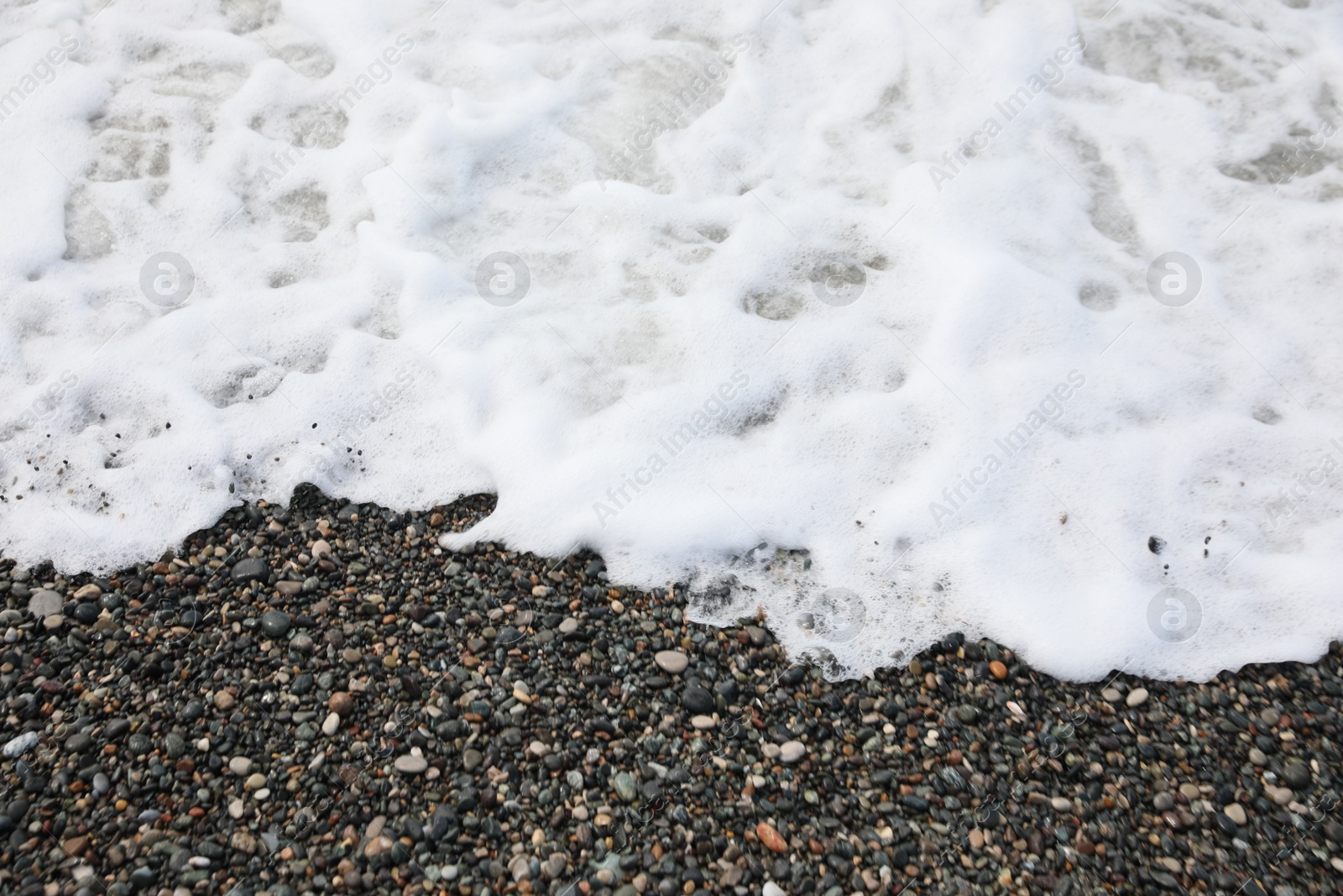 Photo of Picturesque view of beautiful sea wave on pebble beach