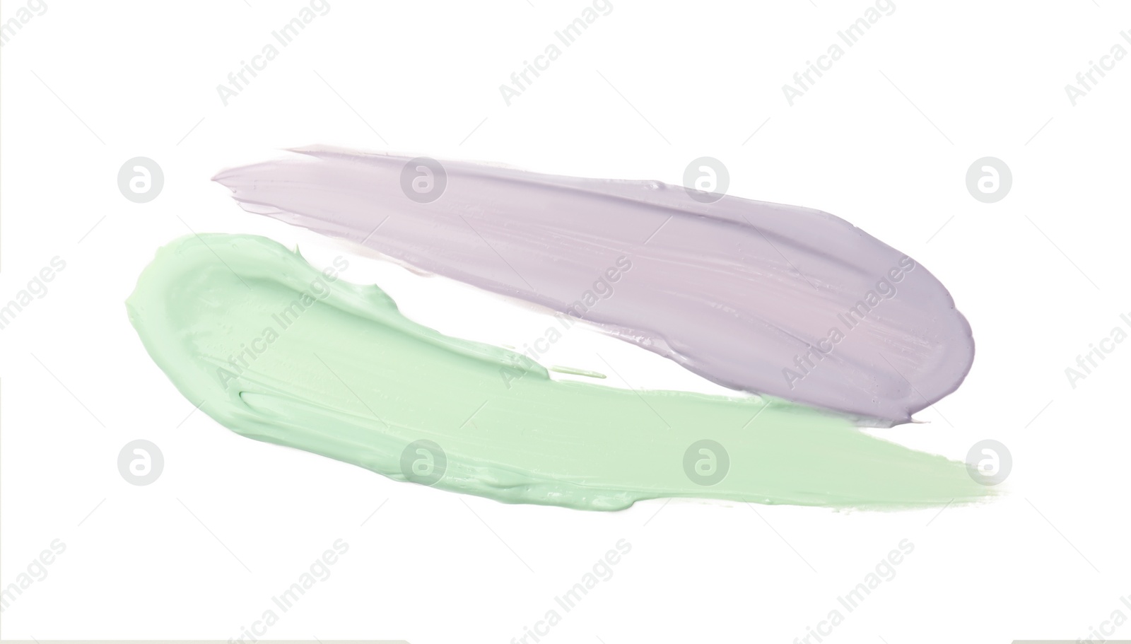 Photo of Strokes of green and purple color correcting concealers isolated on white, top view