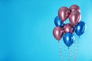 Photo of Bright balloons on color background. Space for text
