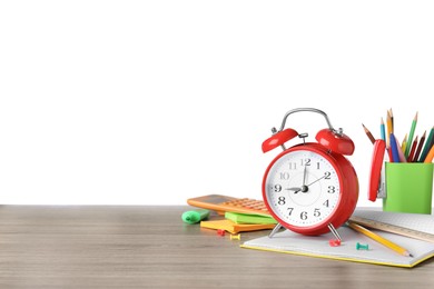 Photo of Red alarm clock and different stationery on wooden table against white background, space for text. School time
