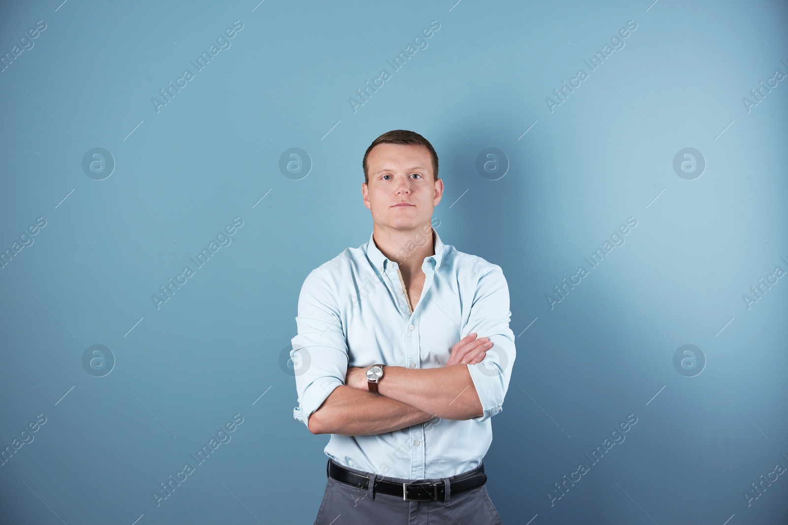 Photo of Confident handsome young man on color background