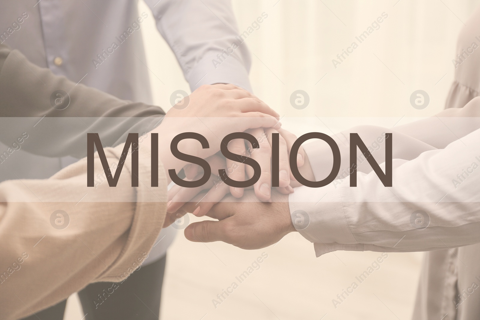 Image of People holding hands together on light background, closeup. Mission concept