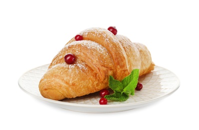 Photo of Tasty croissant with sugar powder and berries on plate against white background