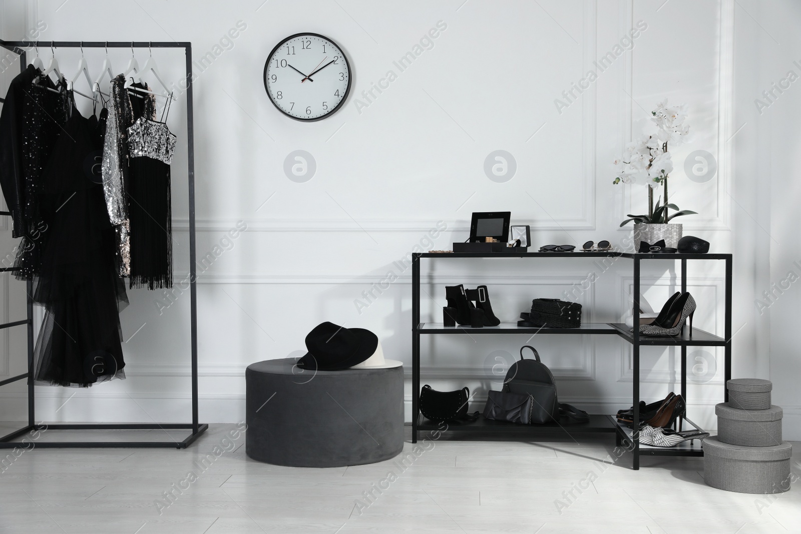 Photo of Stylish dressing room interior with trendy clothes, shoes and accessories