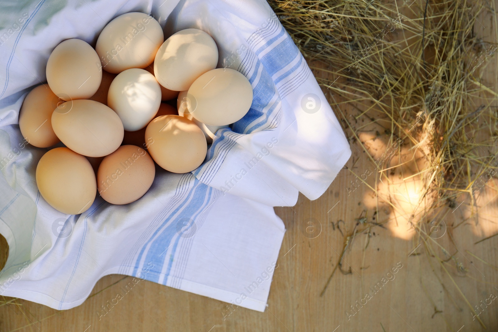 Photo of Fresh raw eggs on wooden table, top view. Space for text