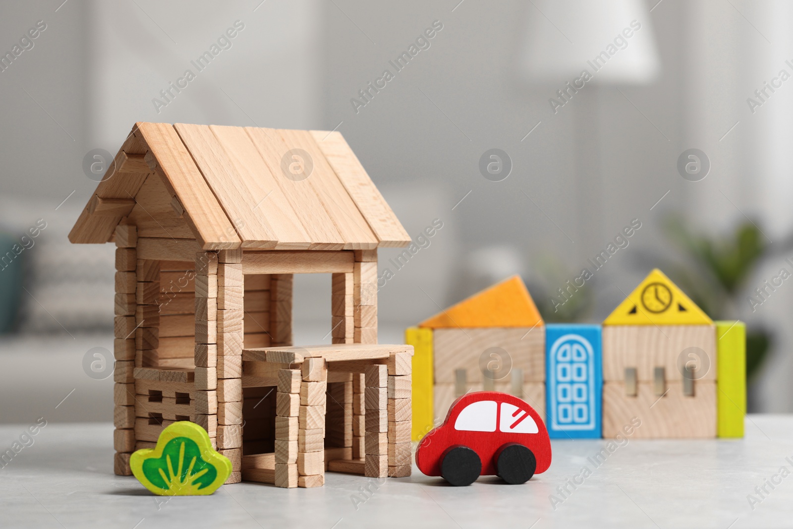 Photo of Set of wooden toys on light grey table indoors, closeup. Children's development