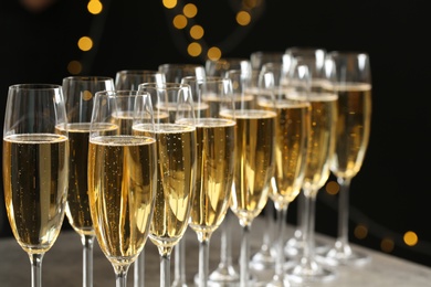 Photo of Glasses of champagne on blurred background, closeup. Space for text