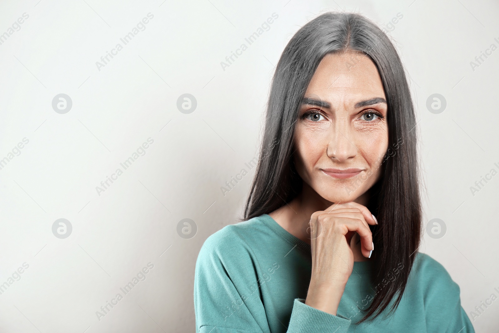 Image of Portrait of senior woman on light background