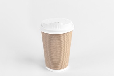 Paper cup with plastic lid on light background. Coffee to go