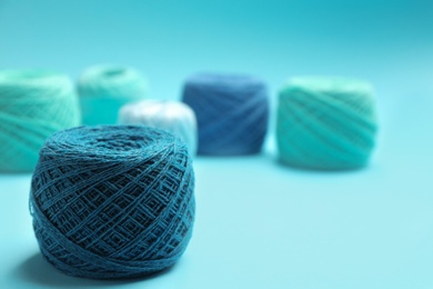 Photo of Clew of knitting threads on color background, space for text. Sewing stuff