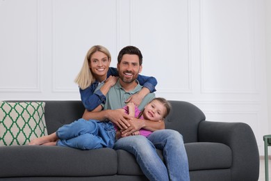 Photo of Portrait of happy family with child on sofa at home