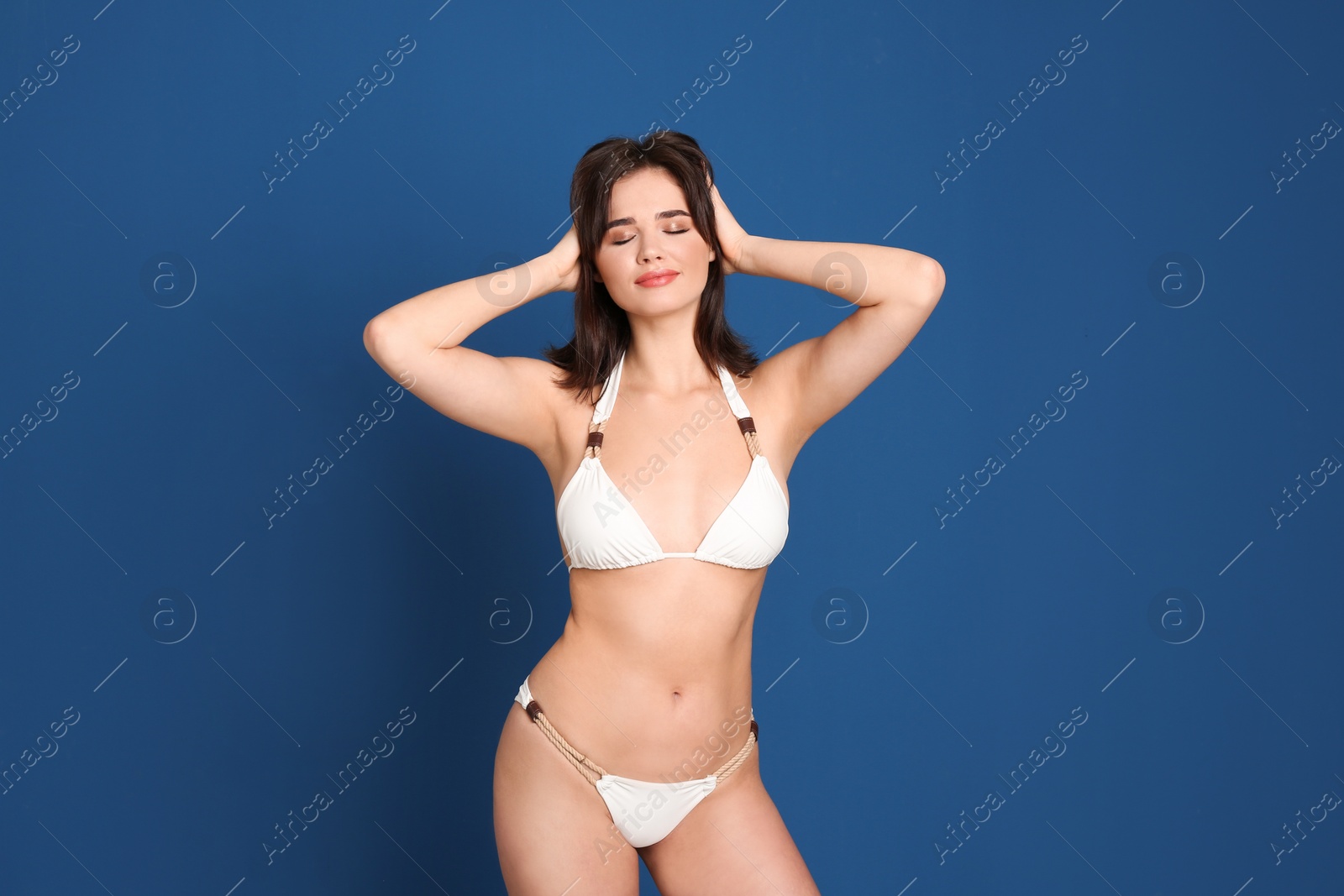 Photo of Beautiful woman in stylish bikini on blue background