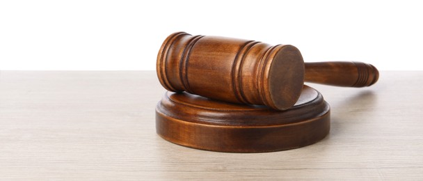 Photo of Wooden gavel on light table against white background. Space for text